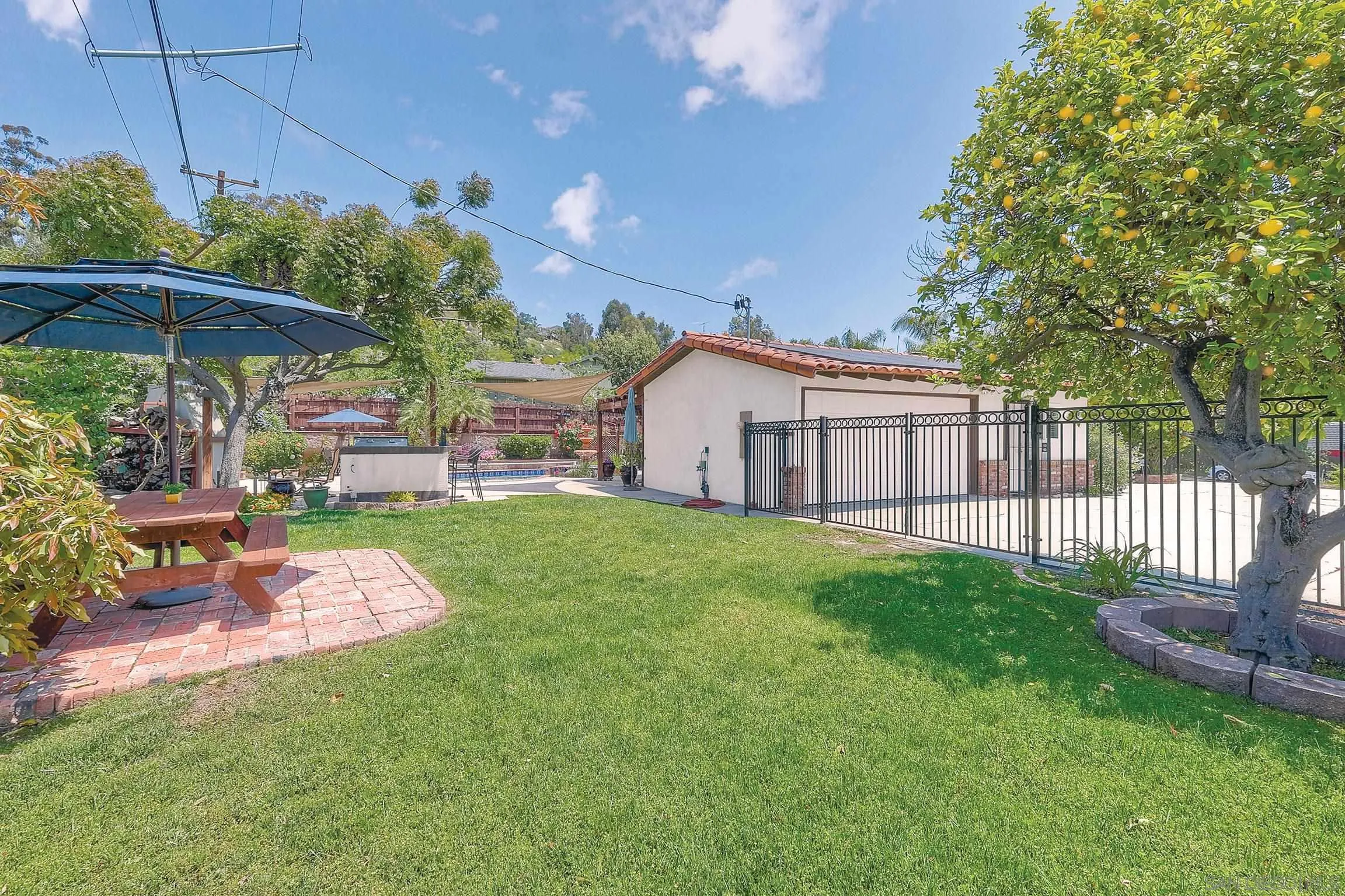 1996 Valley Rim Road El Cajon, CA 92019 - Photo 40 of 74 a view of a porch with a table and chairs under an umbrella
