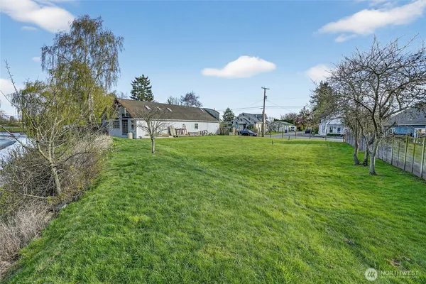 a view of a big yard with plants and a garden