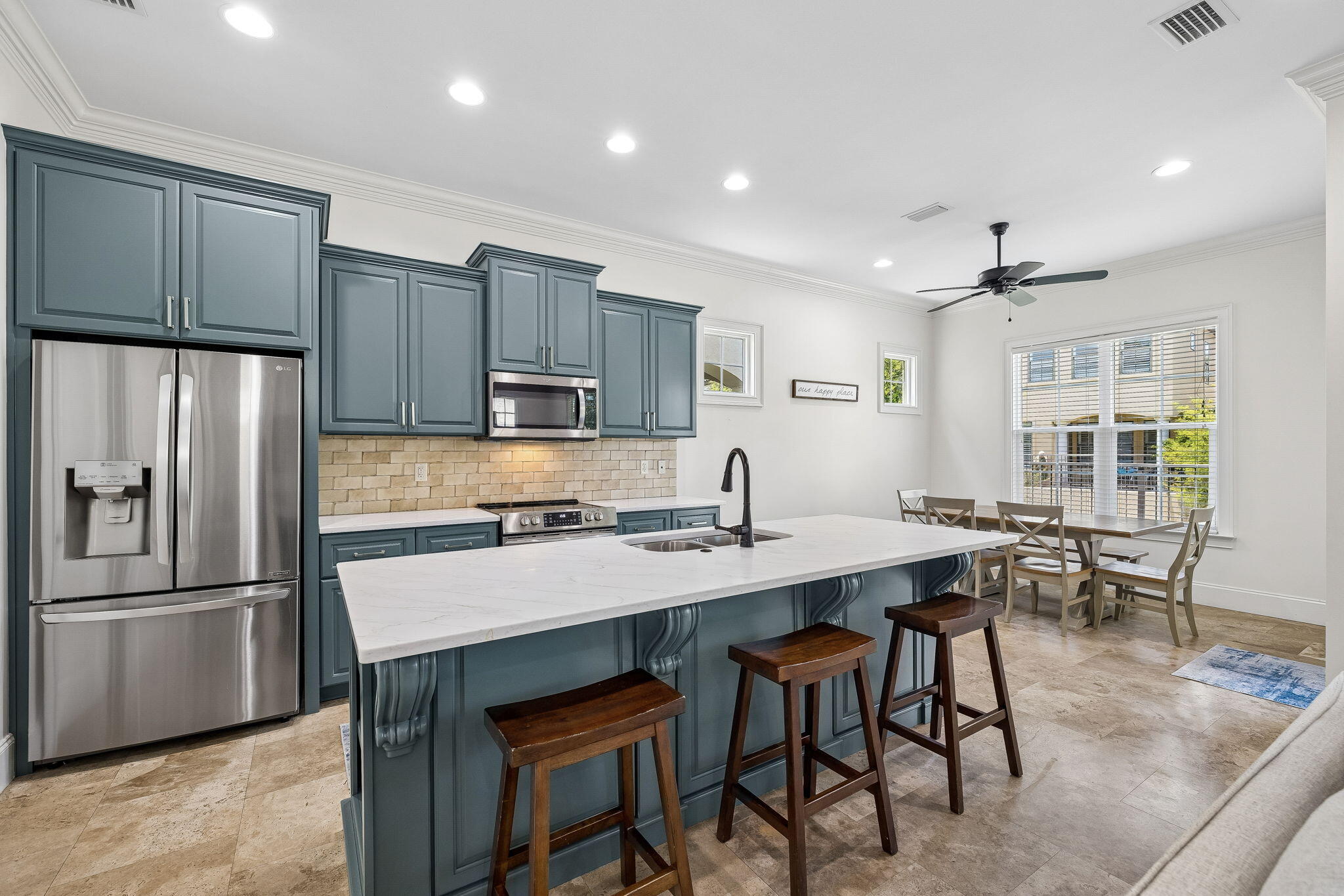 1973 Baytowne Loop Miramar Beach, FL 32550 - Photo 9 of 38 a kitchen with stainless steel appliances granite countertop a sink a stove a refrigerator and white cabinets with wooden floor