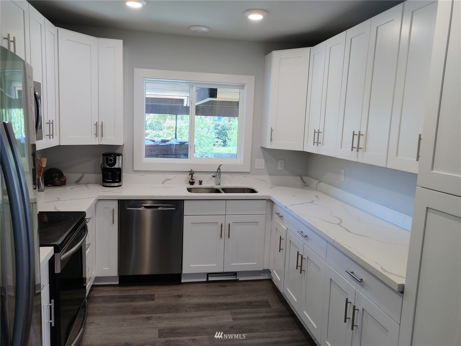3506 Rockefeller Avenue Everett, WA 98201 - Photo 5 of 27 a kitchen with a sink stove and cabinets
