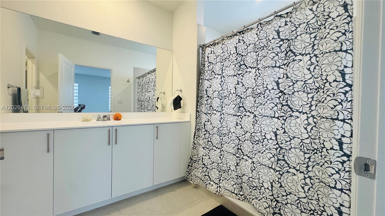 19479 Southwest 340th Street, Unit 1 Homestead, FL 33034 - Photo 26 of 58 a bathroom with a shower and a sink