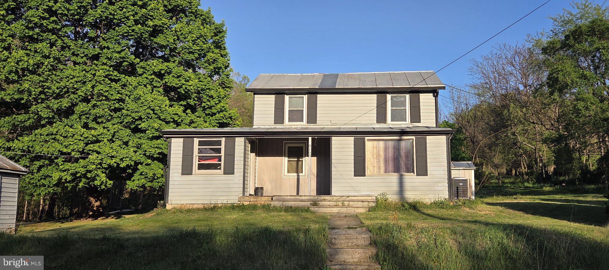 8168 Daphna Road Broadway, VA 22815 - Photo 1 of 21 Charming home with lush greenery backdrop.