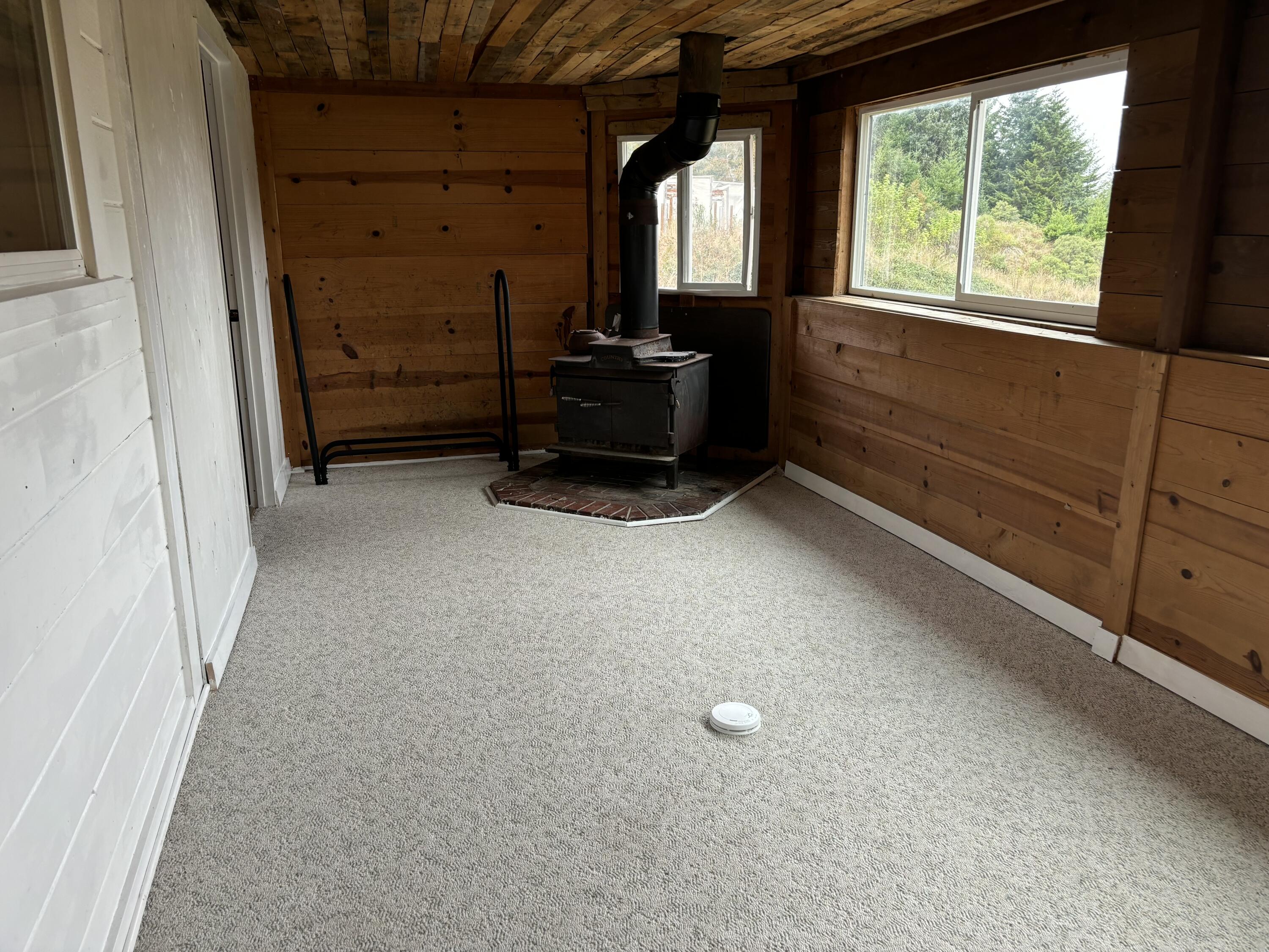 2440 Mattole Road Ferndale, CA 95536 - Photo 7 of 34 Family room with peak of ocean and wood stove