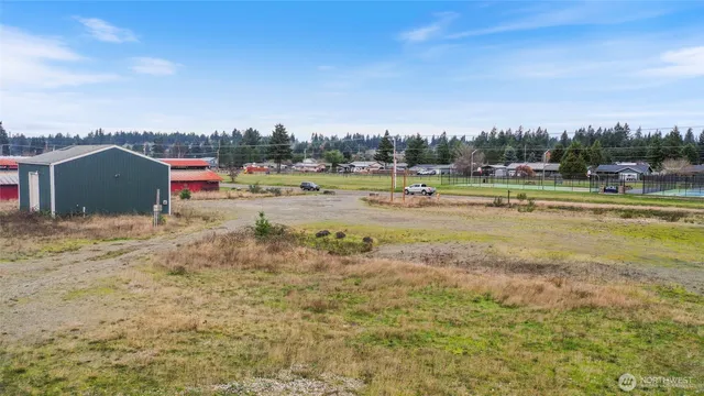 a view of a lake with a big yard and large trees
