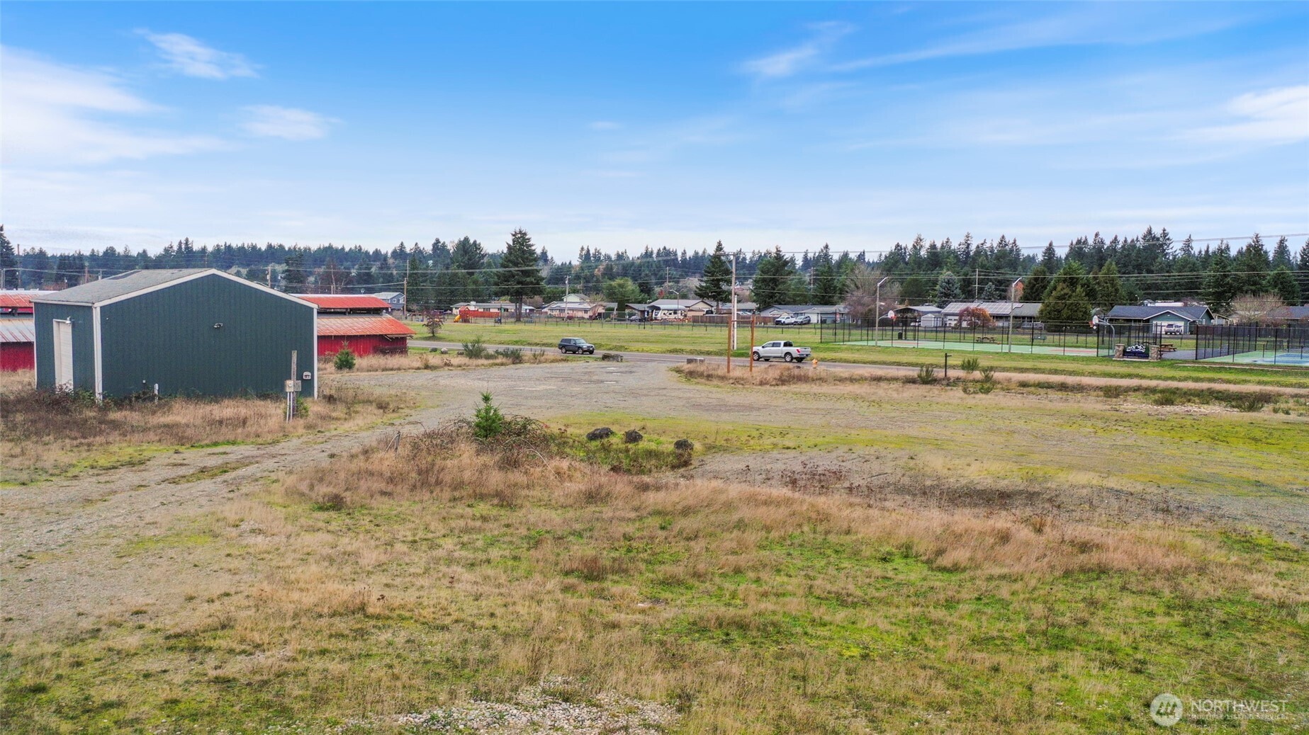 309 Binghampton Street Rainier, WA 98576 - Photo 2 of 11 a view of a lake with a big yard and large trees