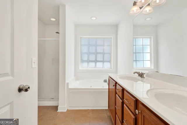 a spacious bathroom with a double vanity sink mirror and toilet