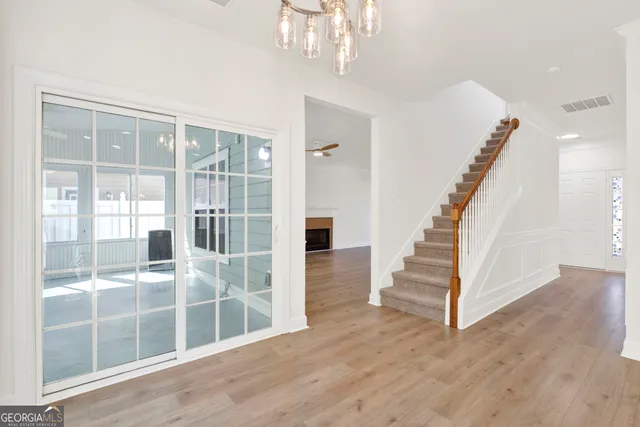 a view of entryway and hall with wooden floor