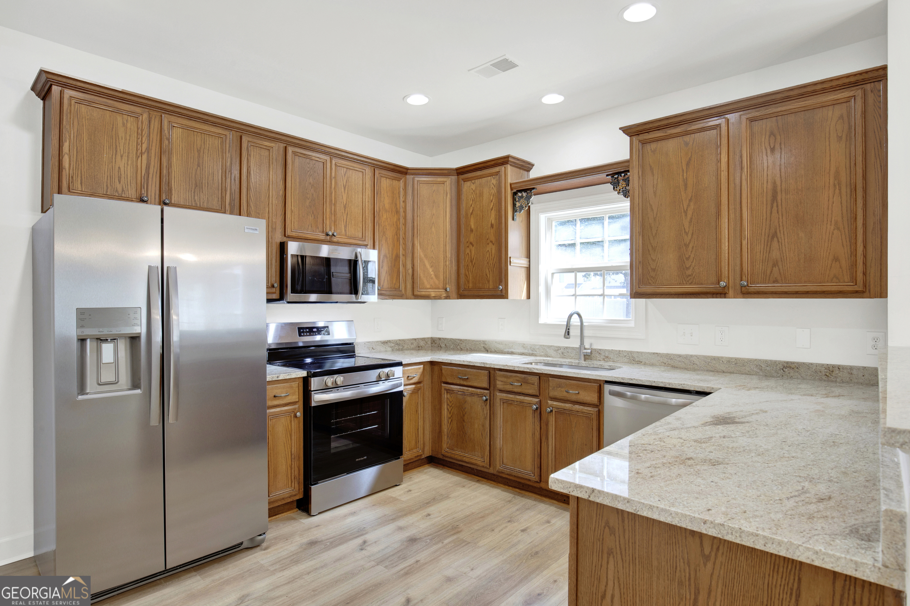 18 Stone Gate Court Pooler, GA 31322 - Photo 6 of 32 a kitchen with stainless steel appliances granite countertop a refrigerator sink and cabinets
