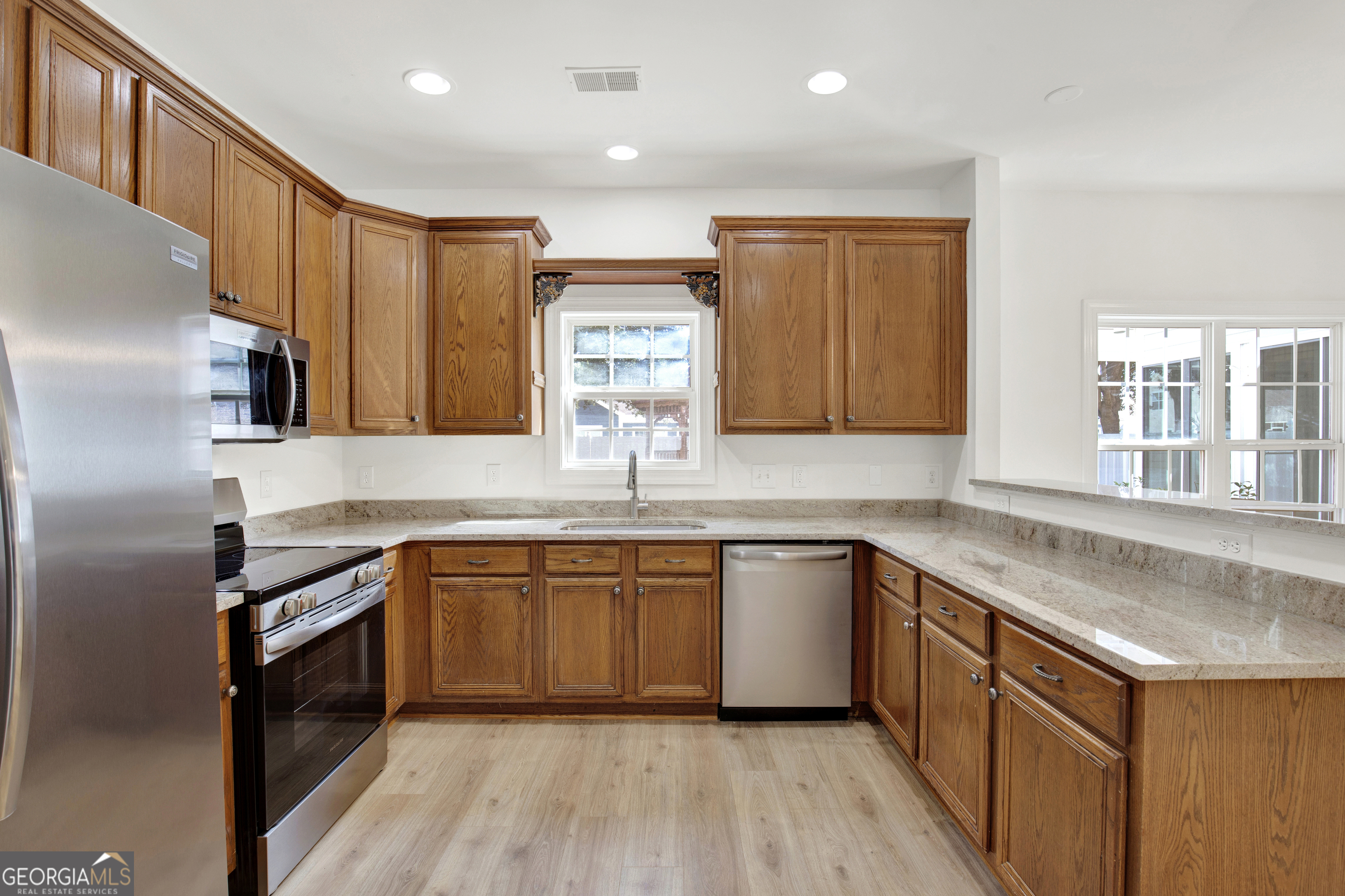 18 Stone Gate Court Pooler, GA 31322 - Photo 7 of 32 a kitchen with stainless steel appliances granite countertop a sink stove and refrigerator