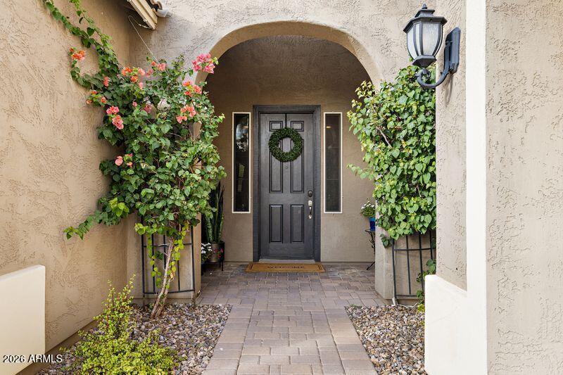 7871 South Stuart Avenue Gilbert, AZ 85298 - Photo 3 of 77 a front view of a house with a garden