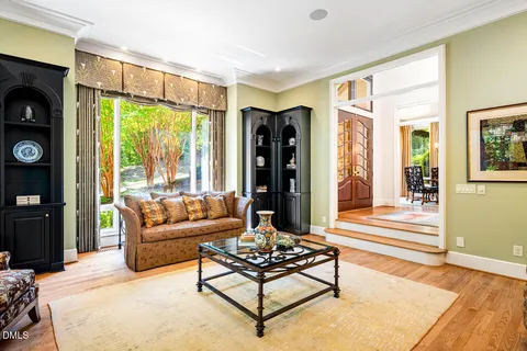 a living room with furniture fireplace and a large window