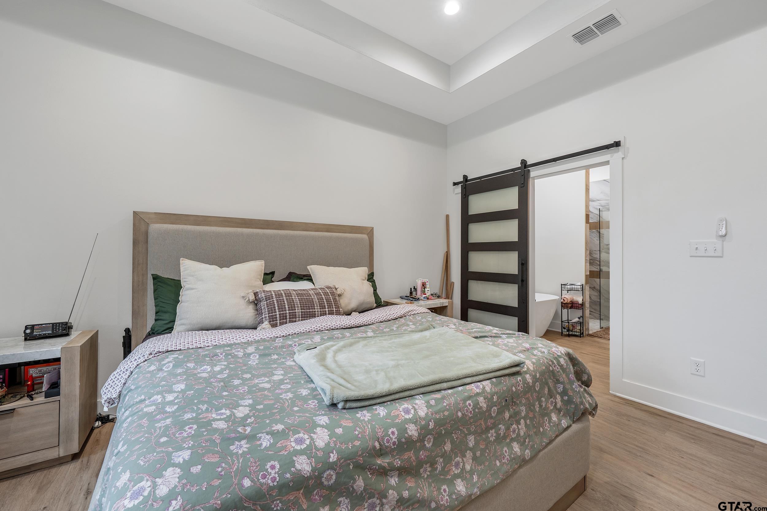 16837 Wilson Road Tyler, TX 75707 - Photo 21 of 44 a bedroom with a large bed and a window