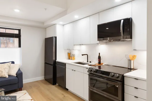 a kitchen with a sink and a stove top oven