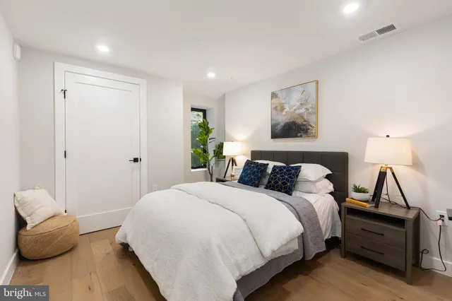 a view of a hallway with wooden floor and entryway