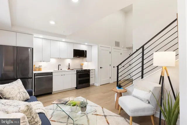 a kitchen with stainless steel appliances kitchen island granite countertop a refrigerator and a stove top oven