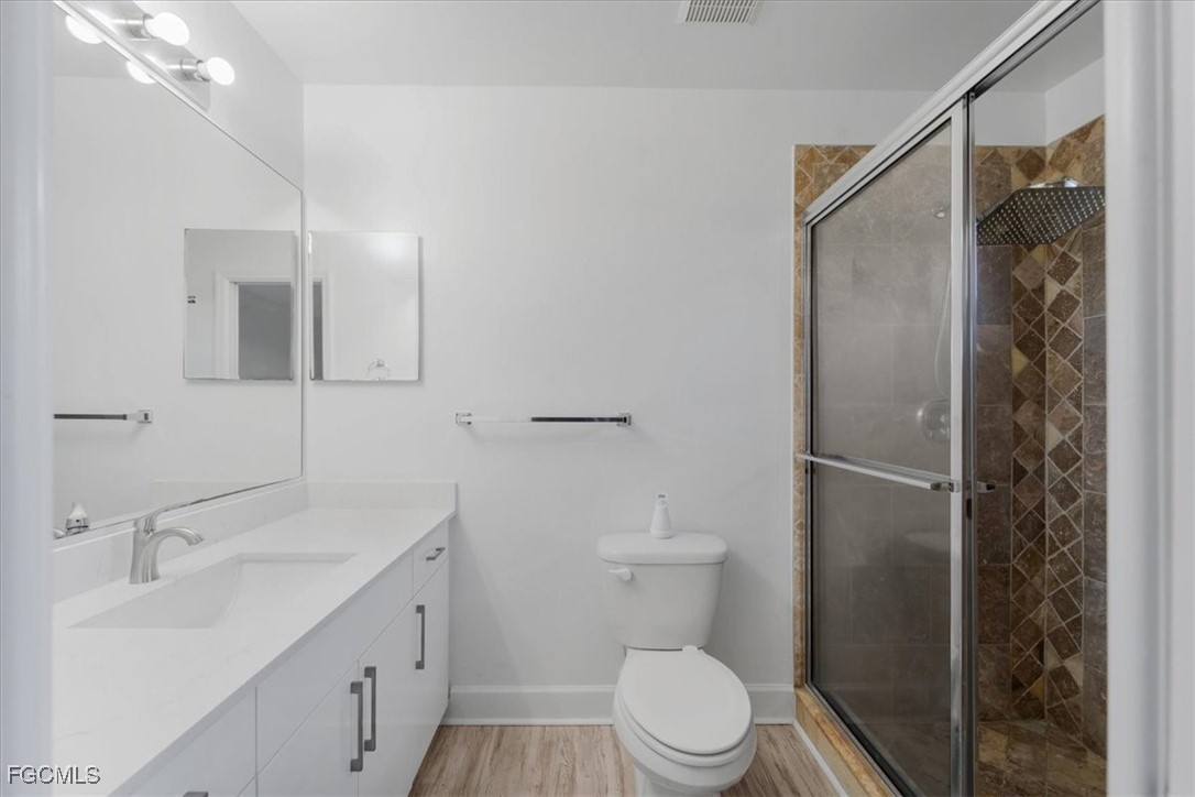 234 Pullman Street Lehigh Acres, FL 33974 - Photo 35 of 50 a bathroom with a sink a toilet and shower