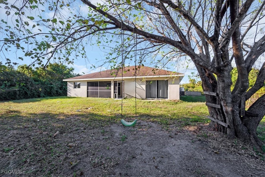 234 Pullman Street Lehigh Acres, FL 33974 - Photo 47 of 50 a view of house with outdoor space and tub
