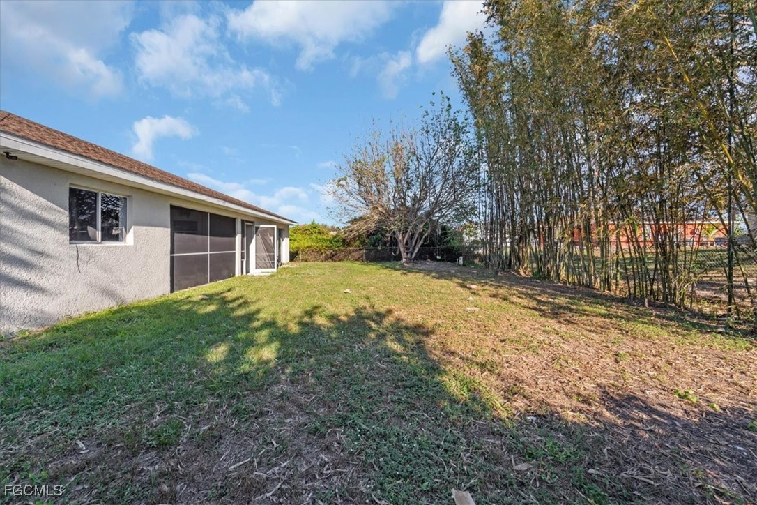 234 Pullman Street Lehigh Acres, FL 33974 - Photo 49 of 50 a view of a house with a backyard