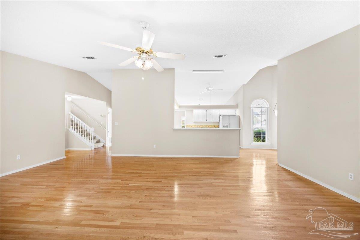 3485 Ashmore Lane Pace, FL 32571 - Photo 11 of 49 a view of an empty room with window and wooden floor
