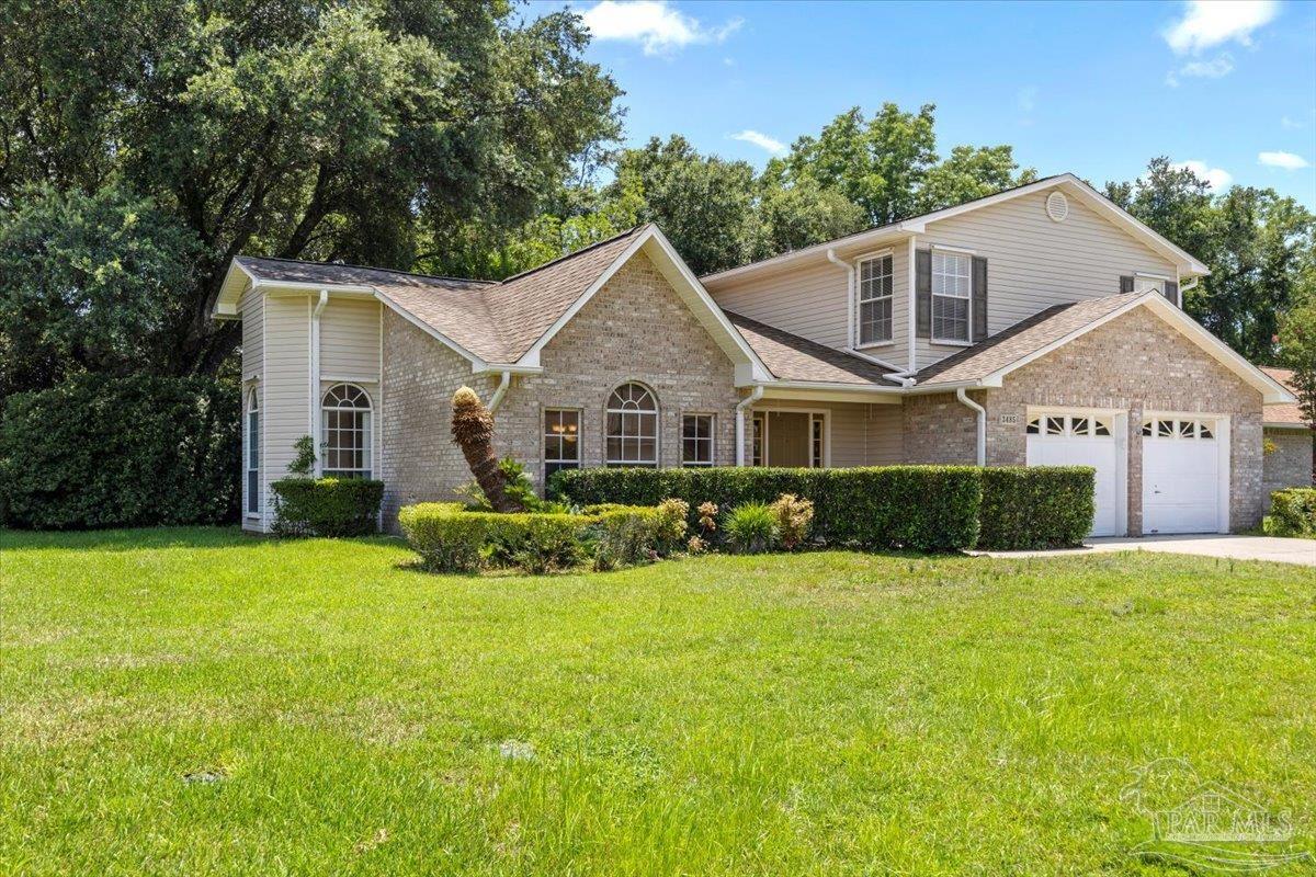 3485 Ashmore Lane Pace, FL 32571 - Photo 2 of 49 a front view of a house with a yard and garage