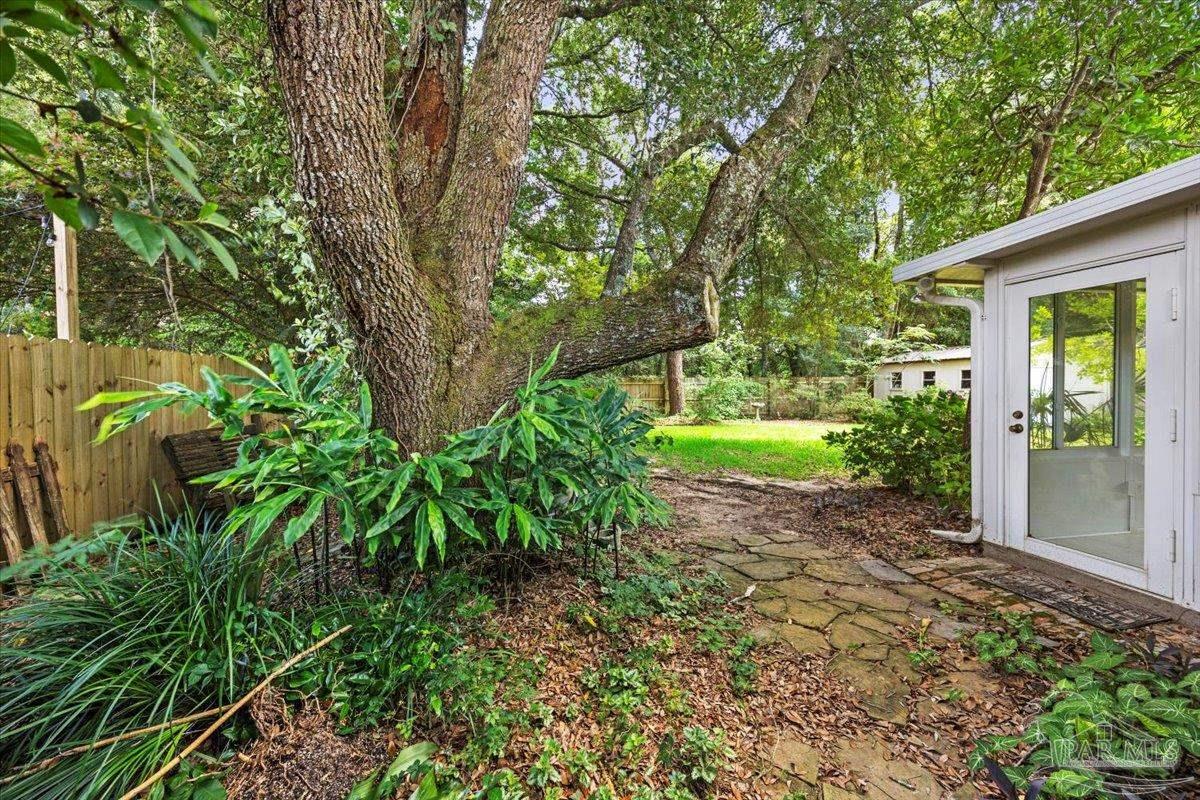 3485 Ashmore Lane Pace, FL 32571 - Photo 24 of 49 a view of a yard with plants and large trees