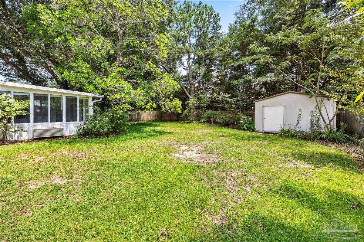 3485 Ashmore Lane Pace, FL 32571 - Photo 25 of 49 a view of a house with backyard and garden