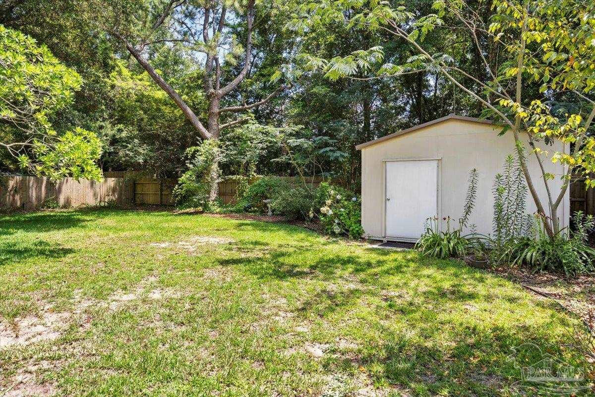 3485 Ashmore Lane Pace, FL 32571 - Photo 26 of 49 a view of a backyard with large trees
