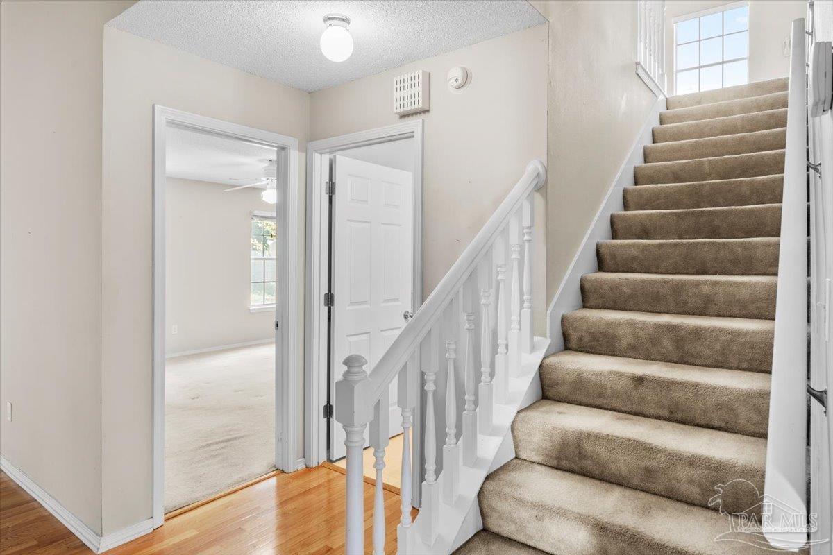 3485 Ashmore Lane Pace, FL 32571 - Photo 30 of 49 a view of staircase with lots of frames on wall