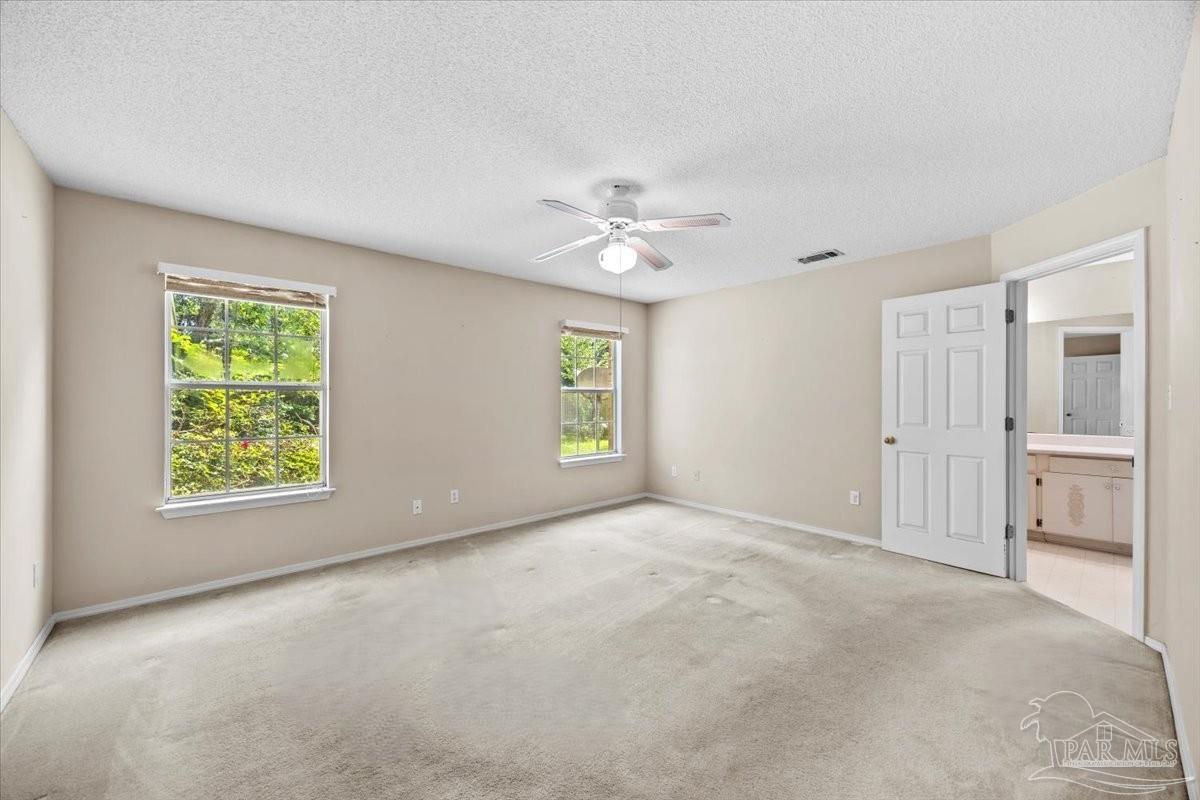 3485 Ashmore Lane Pace, FL 32571 - Photo 31 of 49 an empty room with windows and ceiling fan