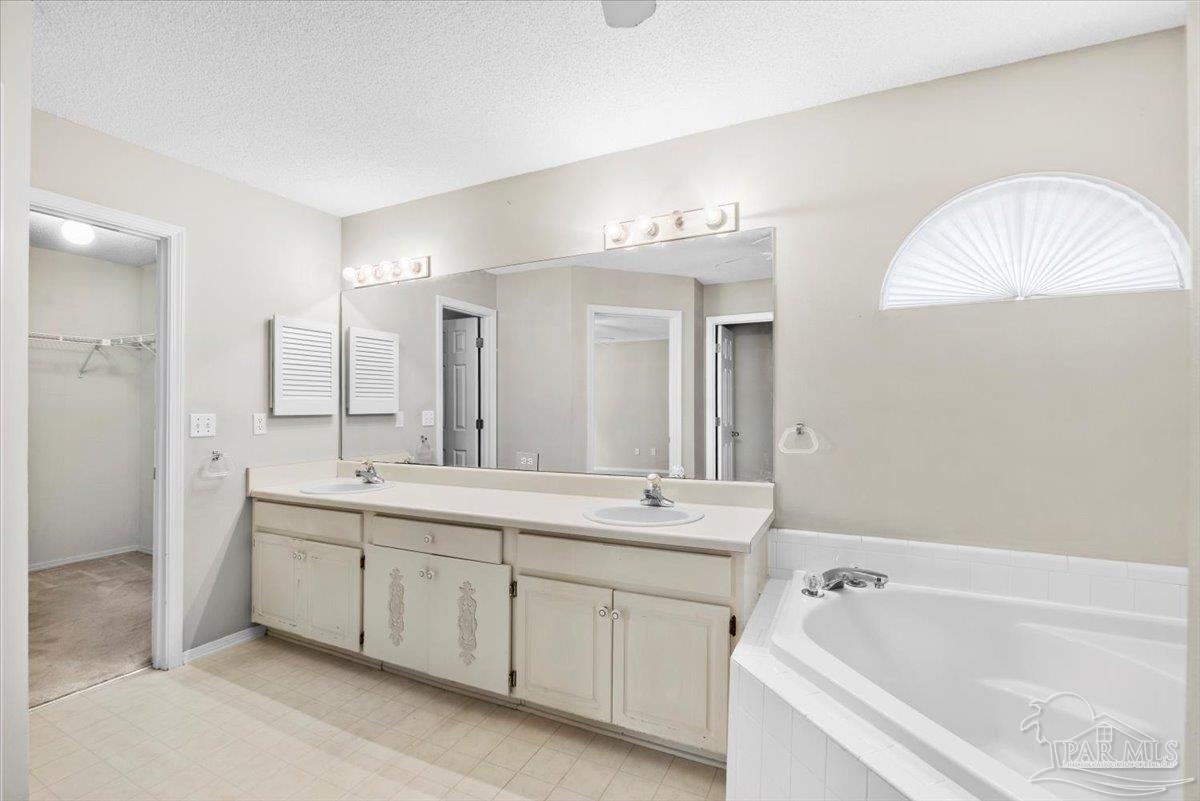 3485 Ashmore Lane Pace, FL 32571 - Photo 33 of 49 a spacious bathroom with a tub sink and mirror