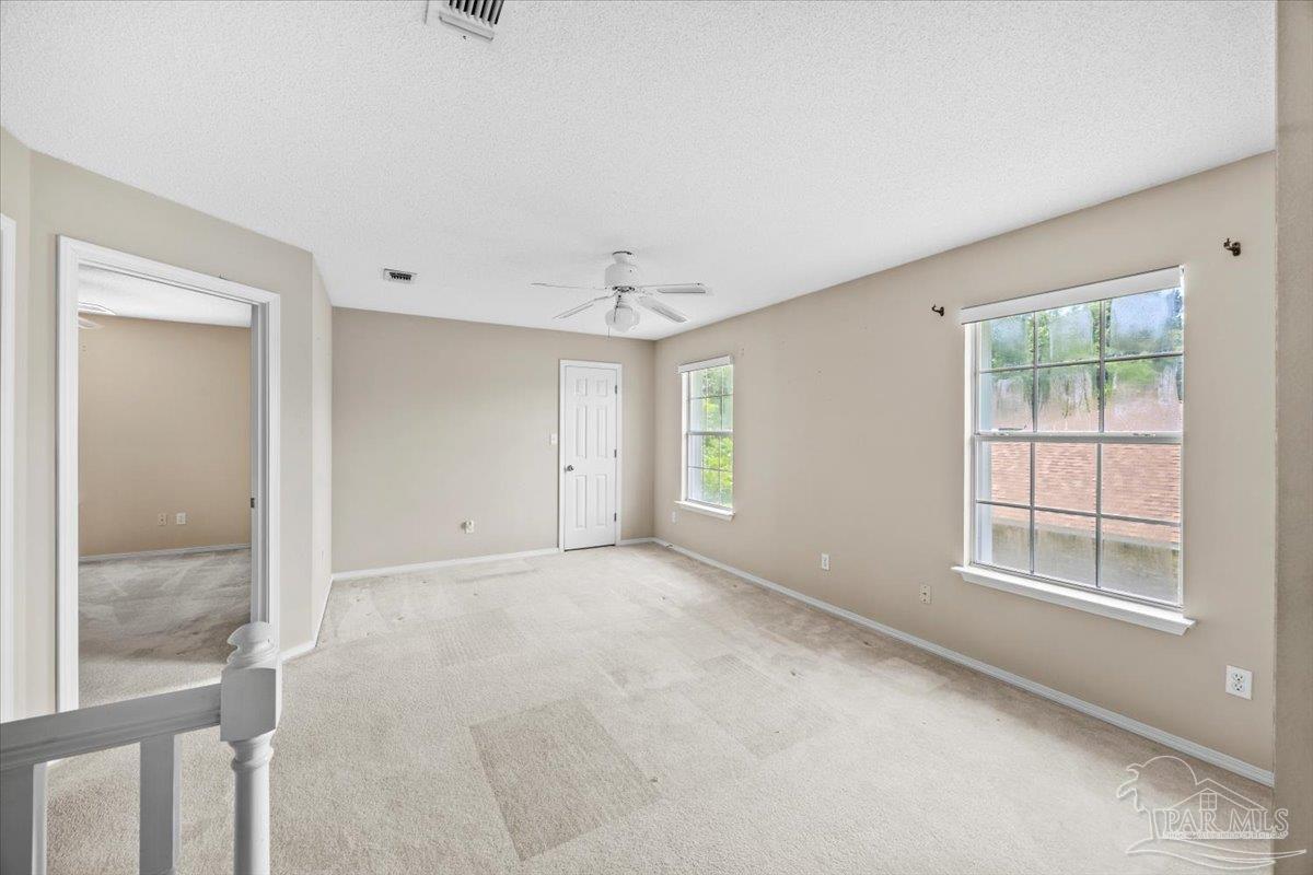 3485 Ashmore Lane Pace, FL 32571 - Photo 37 of 49 an empty room with windows and closet