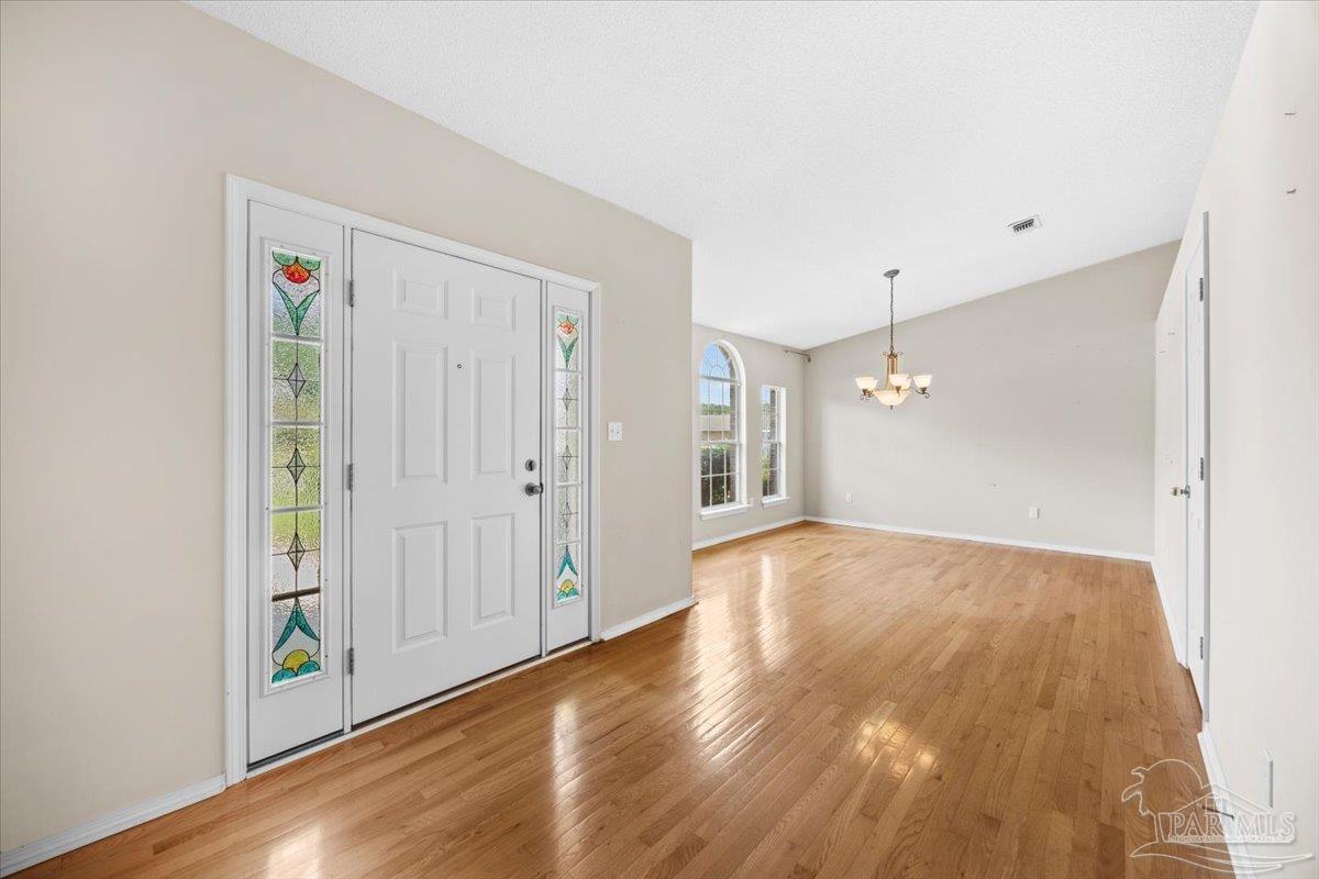 3485 Ashmore Lane Pace, FL 32571 - Photo 4 of 49 a view of empty room with wooden floor