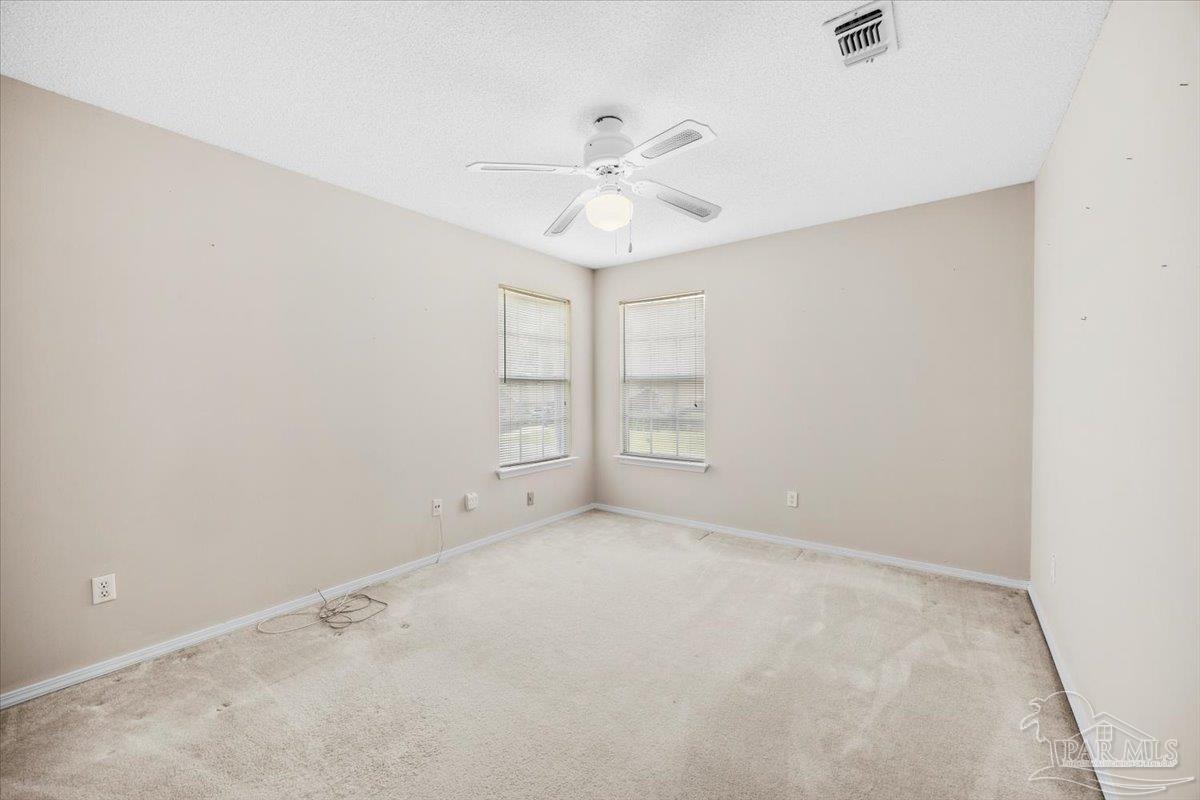 3485 Ashmore Lane Pace, FL 32571 - Photo 42 of 49 an empty room with closet and a ceiling fan