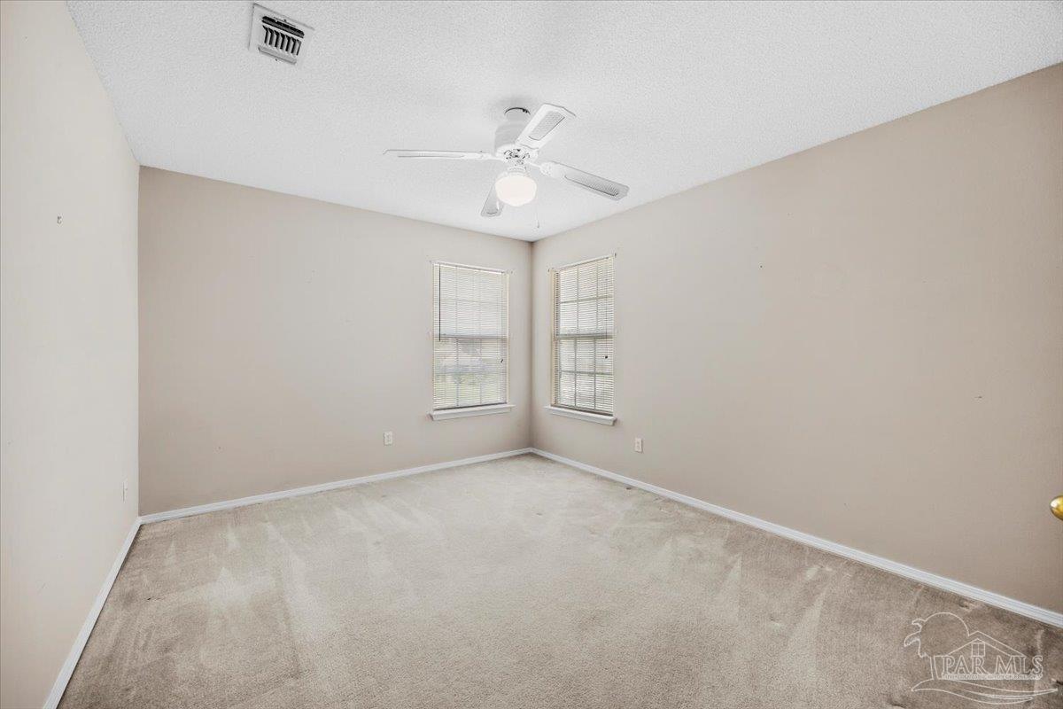 3485 Ashmore Lane Pace, FL 32571 - Photo 43 of 49 an empty room with windows and fan