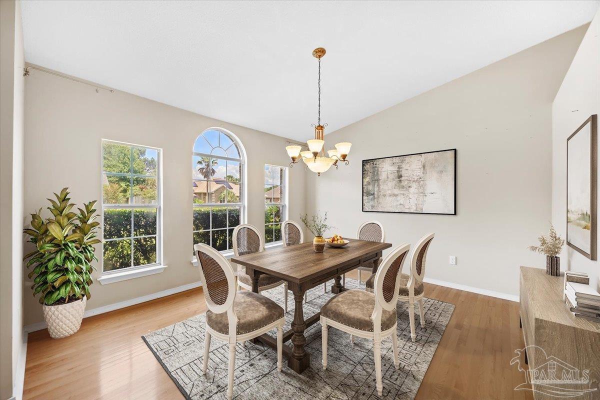 3485 Ashmore Lane Pace, FL 32571 - Photo 5 of 49 a view of a dining room with furniture window and wooden floor