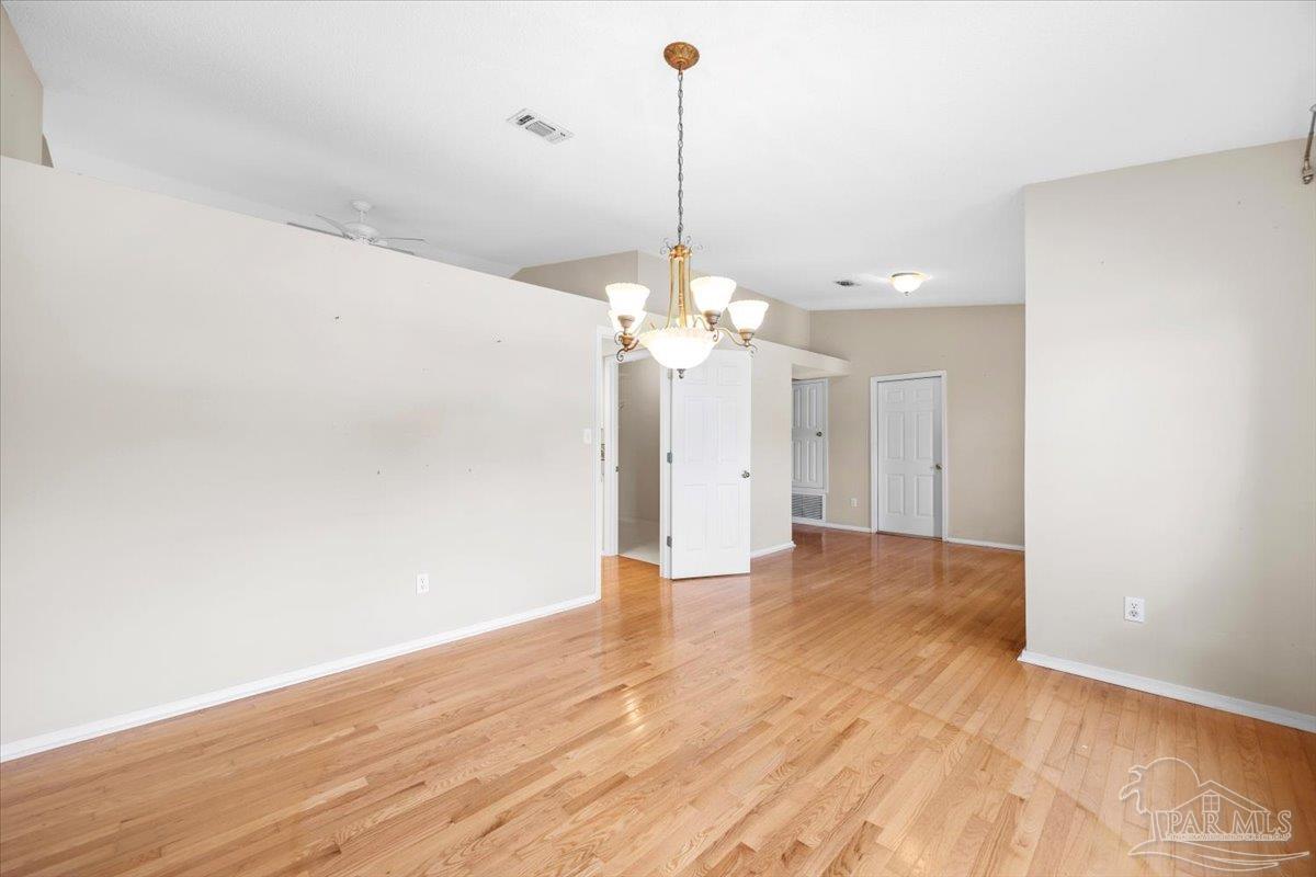 3485 Ashmore Lane Pace, FL 32571 - Photo 7 of 49 a view of a room with wooden floor ceiling fan and window