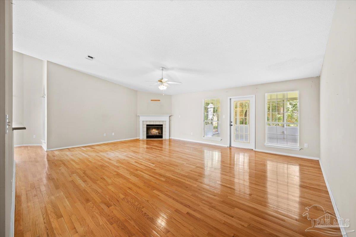 3485 Ashmore Lane Pace, FL 32571 - Photo 9 of 49 a view of empty room with wooden floor and fireplace
