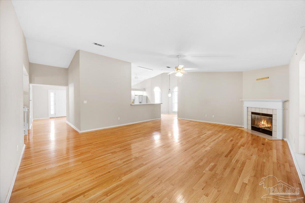 3485 Ashmore Lane Pace, FL 32571 - Photo 10 of 49 a view of empty room with wooden floor and fireplace