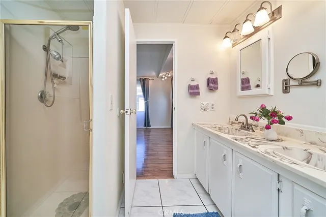 a bathroom with a sink vanity and mirror