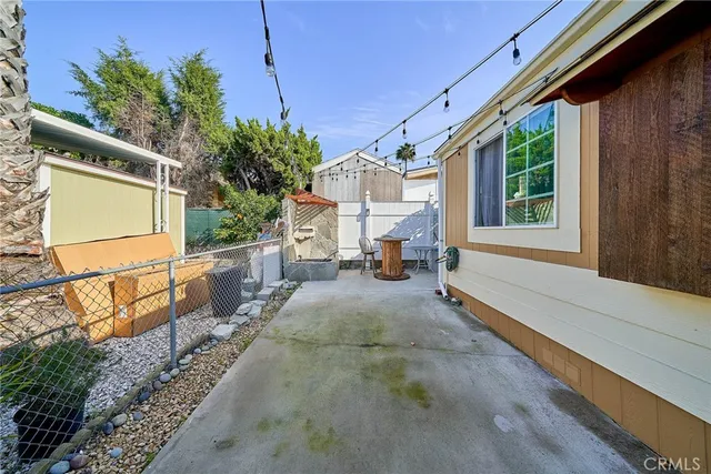 a view of a porch with wooden floor and iron fence