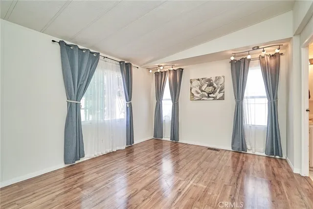 a view of a room with wooden floor and a window