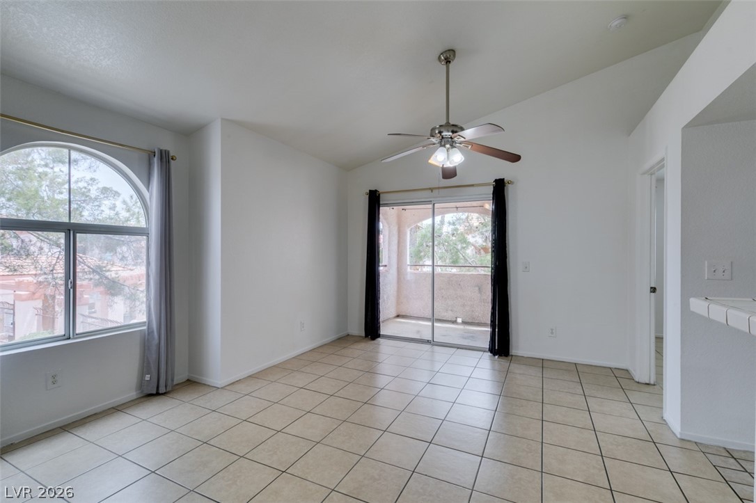 7570 West Flamingo Road, Unit 252 Las Vegas, NV 89147 - Photo 14 of 44 A living space offers a tiled floor, an arched window, and direct balcony access.