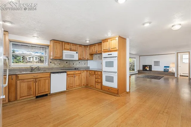 a kitchen with granite countertop a refrigerator and a sink
