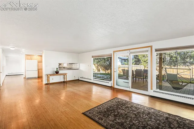 a view of a livingroom with wooden floor and a rug