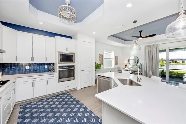 a living room with furniture a flat screen tv and a window