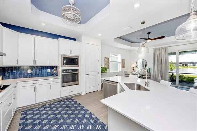 a living room with furniture a flat screen tv and a window