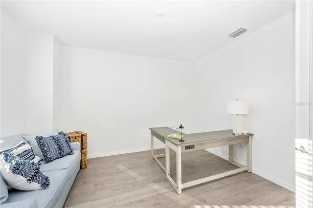 a bedroom with a bed a window and a chandelier