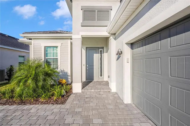 a living room with furniture kitchen view and a large window