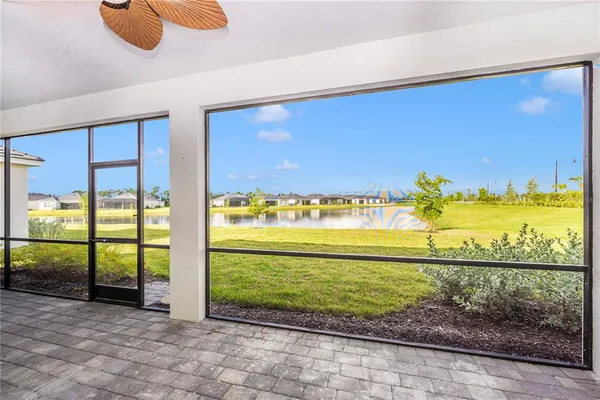 a swimming pool view with a seating space and a garden view