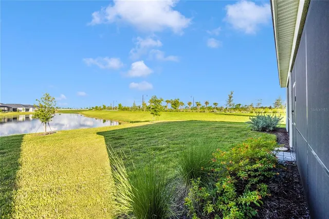 a view of a swimming pool with an ocean and trees